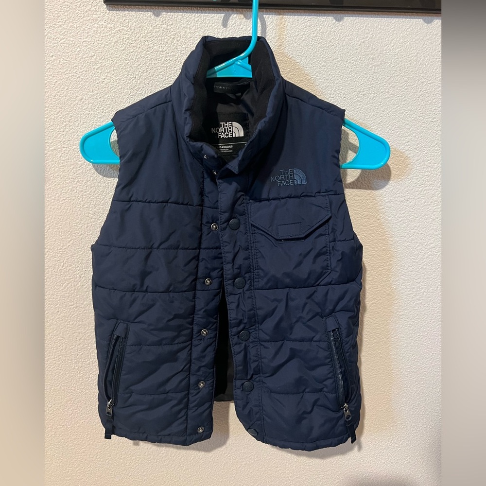 Boys North face puffy vest. Navy blue. Size 7/8.  Great condition.